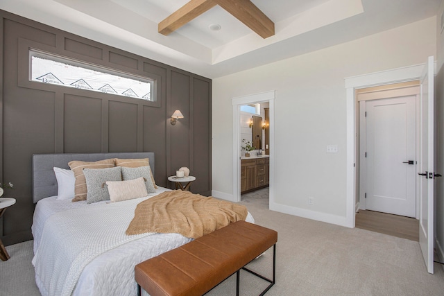 carpeted bedroom with beamed ceiling, ceiling fan, and connected bathroom