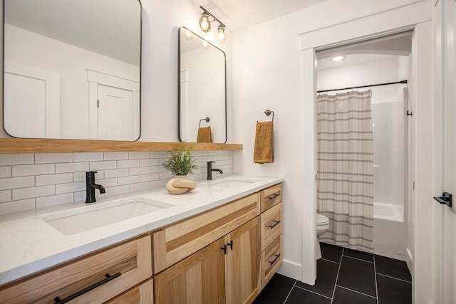 full bathroom featuring backsplash, tile patterned floors, vanity, shower / bath combo with shower curtain, and toilet