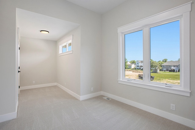 unfurnished room with light carpet