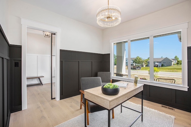 home office featuring an inviting chandelier and light wood-type flooring