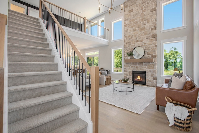 living room with a high ceiling, a wealth of natural light, and hardwood / wood-style floors