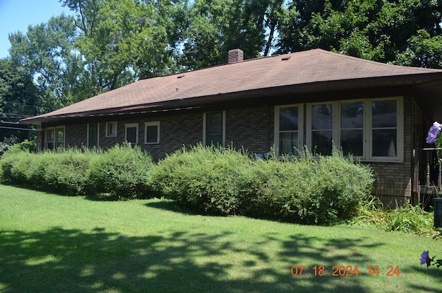 156 Western Ave, Benton Harbor, MI 49022 - back of property featuring a yard, a chimney, brick siding, and a shingled roof