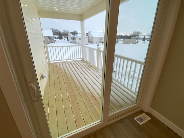 view of snow covered back of property