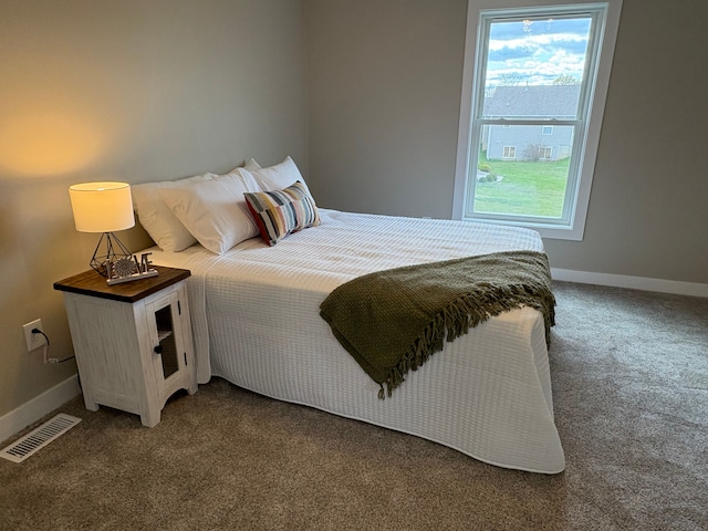 1430 N Mallard Cir, Owosso, MI 48867 - carpeted bedroom featuring visible vents, multiple windows, and baseboards
