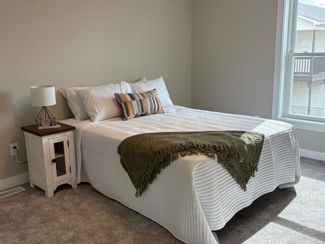 1430 N Mallard Cir, Owosso, MI 48867 - bedroom with baseboards, visible vents, and carpet