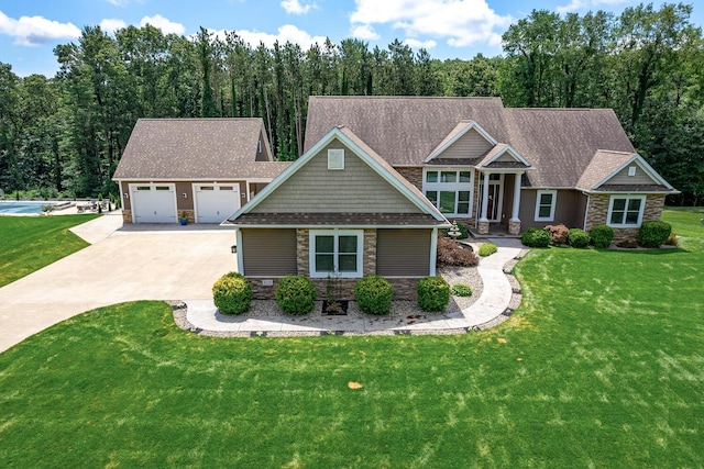 craftsman house with a garage and a front lawn