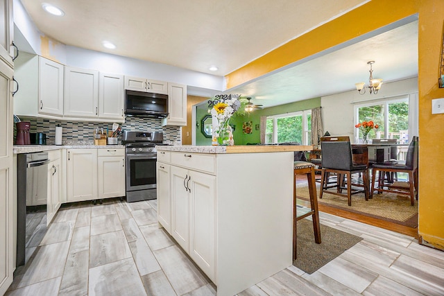 kitchen featuring hanging light fixtures, a kitchen island, light hardwood / wood-style floors, white cabinetry, and stainless steel appliances