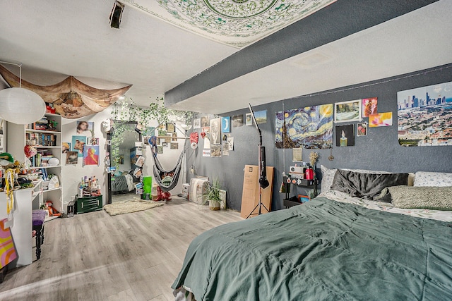 bedroom with a textured ceiling and light hardwood / wood-style floors