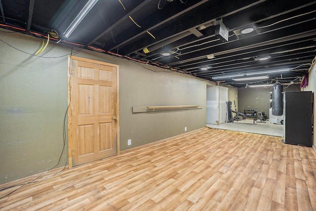 basement with hardwood / wood-style floors