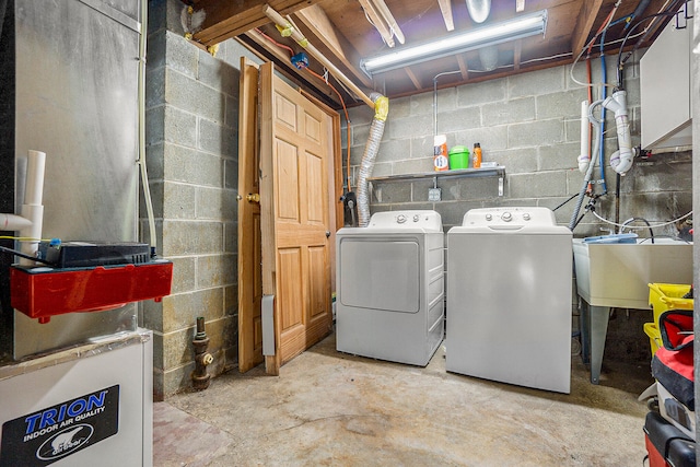 laundry area featuring washer and clothes dryer and sink