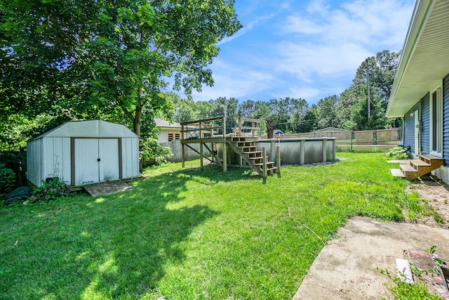 view of yard featuring a pool side deck and a shed