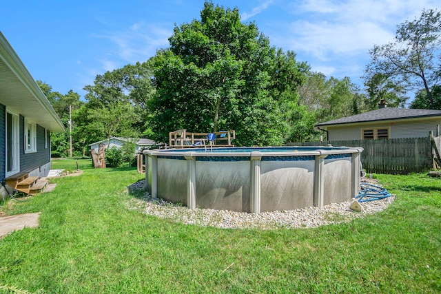 view of swimming pool featuring a lawn