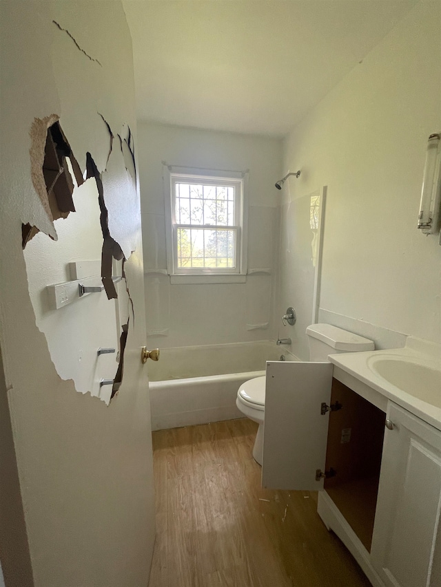 full bathroom featuring wood-type flooring, vanity, toilet, and shower / washtub combination