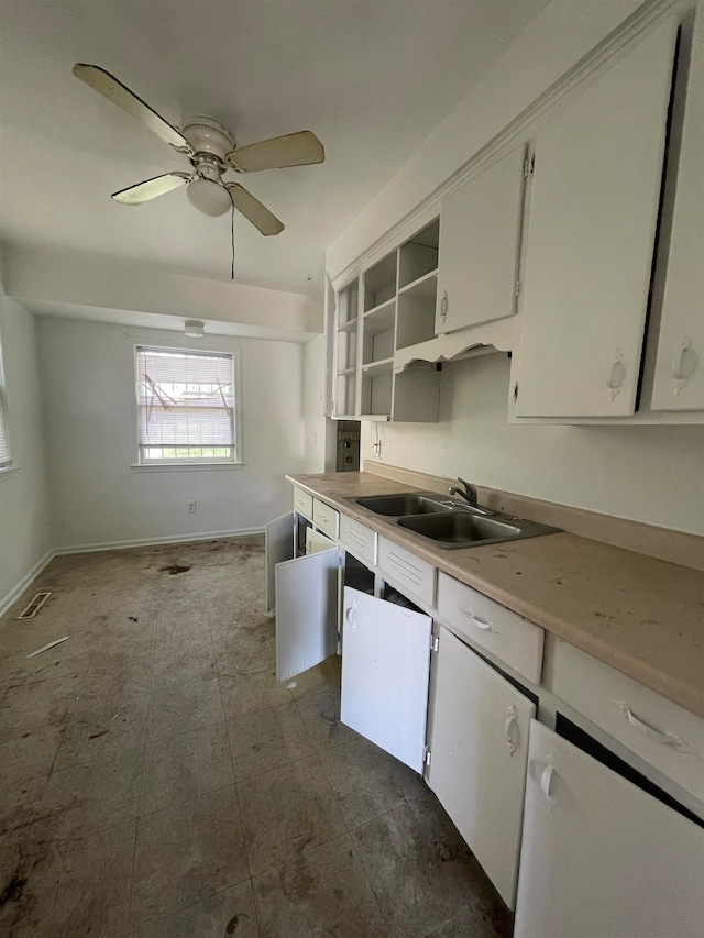 kitchen with white cabinets, ceiling fan, and sink