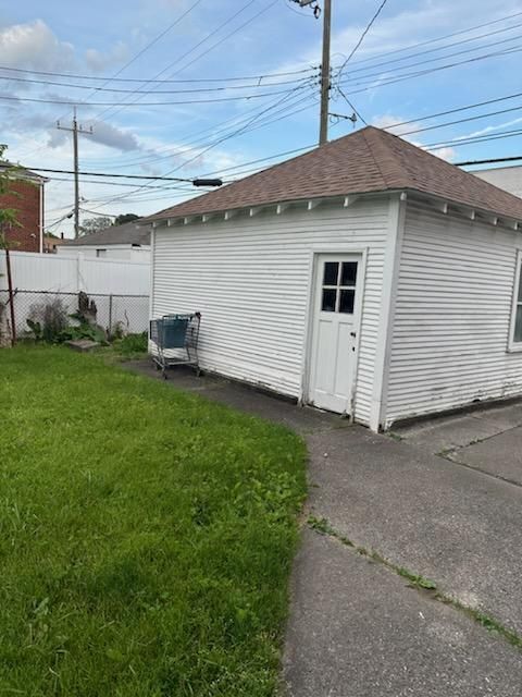 view of outbuilding featuring a lawn