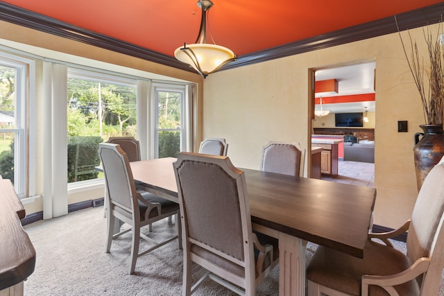 dining area featuring a healthy amount of sunlight and crown molding