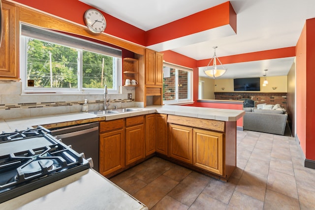 18230 Rainbow Dr, Lathrup Village, MI 48076 - kitchen featuring a sink, a peninsula, decorative backsplash, brown cabinetry, and open floor plan