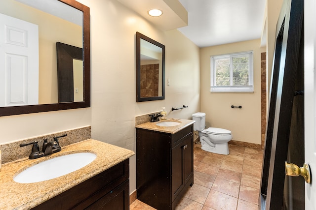 bathroom featuring tile patterned floors, vanity, and toilet