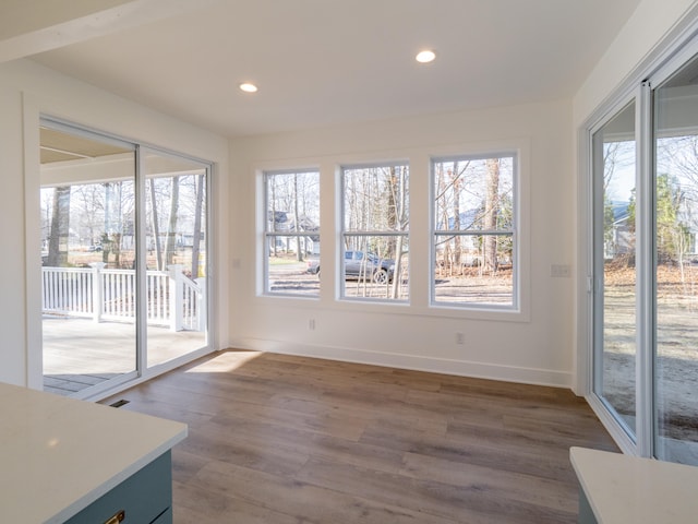 unfurnished dining area with dark hardwood / wood-style floors