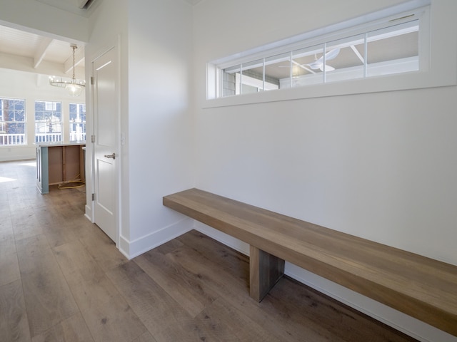 mudroom with beam ceiling, an inviting chandelier, and light hardwood / wood-style flooring