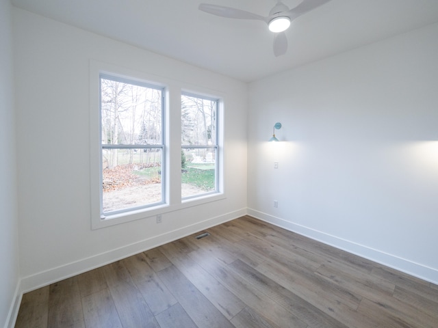 spare room with wood-type flooring and ceiling fan