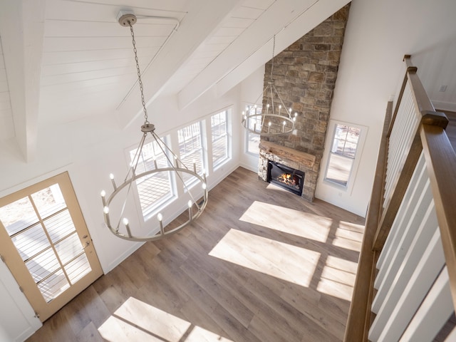 living room with hardwood / wood-style flooring, a healthy amount of sunlight, and a chandelier