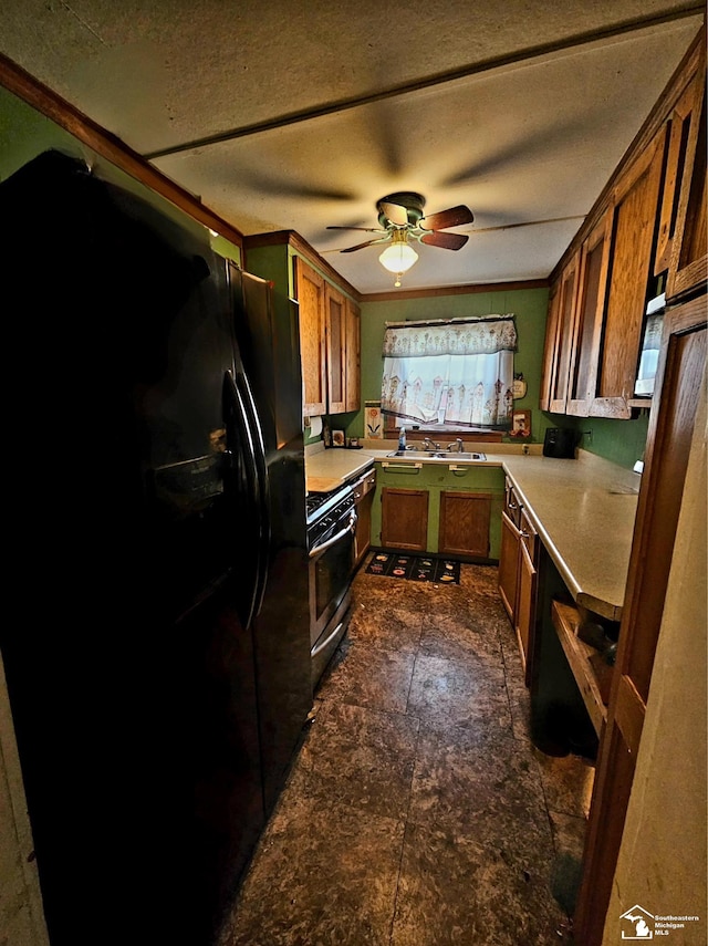 kitchen with black fridge, a textured ceiling, ceiling fan, sink, and stainless steel range with gas cooktop