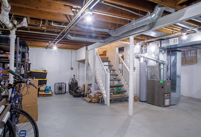 basement featuring heating unit and gas water heater