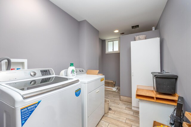 18564 200th, Tustin, MI 49688 - laundry room featuring separate washer and dryer, wood tiled floors, and recessed lighting