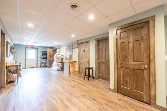 18564 200th, Tustin, MI 49688 - living area with light wood-type flooring, a paneled ceiling, and baseboards