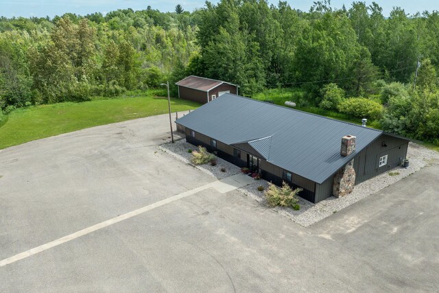 18564 200th, Tustin, MI 49688 - aerial view of property and surrounding area featuring a heavily wooded area