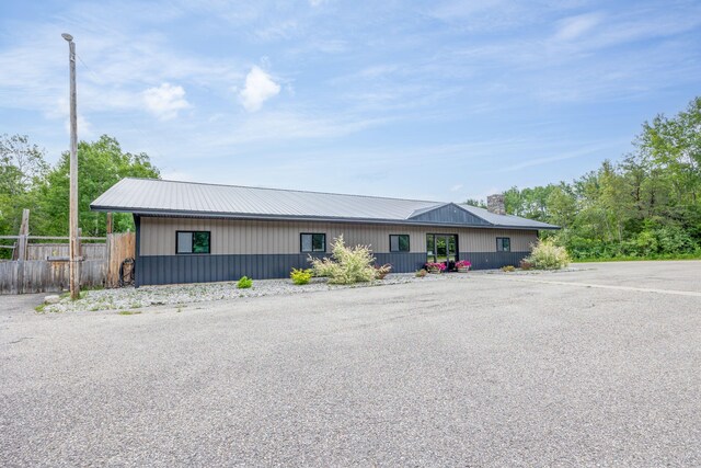 18564 200th, Tustin, MI 49688 - view of front of property featuring uncovered parking, a chimney, and metal roof