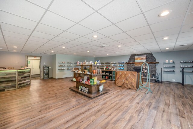 18564 200th, Tustin, MI 49688 - living room featuring a stone fireplace, wood finished floors, recessed lighting, and a drop ceiling