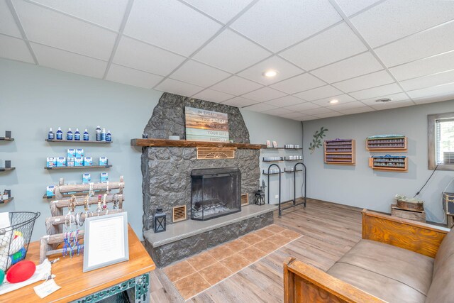 18564 200th, Tustin, MI 49688 - living room with wood finished floors, a paneled ceiling, a stone fireplace, and recessed lighting