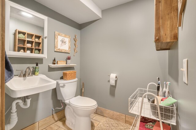 18564 200th, Tustin, MI 49688 - bathroom featuring toilet, a sink, and baseboards