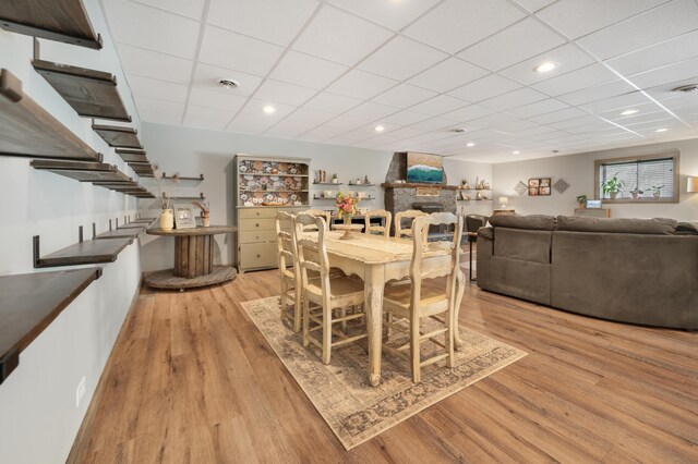 18564 200th, Tustin, MI 49688 - dining room with light wood-style floors, a drop ceiling, and stairway