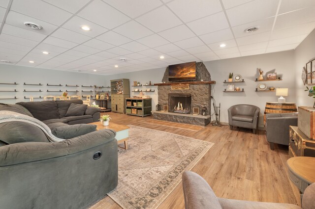 18564 200th, Tustin, MI 49688 - living area featuring a paneled ceiling, light wood-type flooring, a fireplace, and recessed lighting