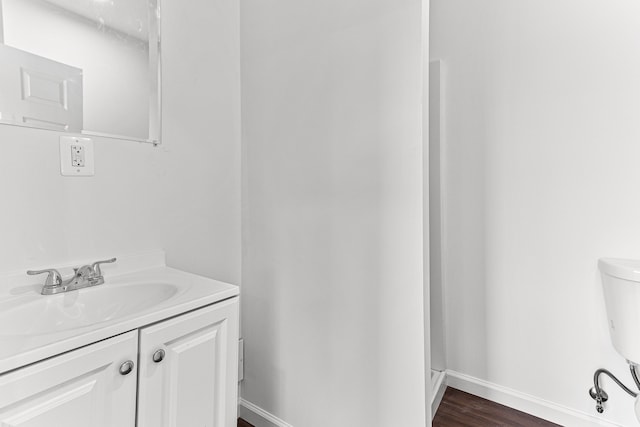 bathroom with vanity, toilet, and wood-type flooring