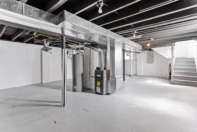 basement featuring electric panel, water heater, and heating unit