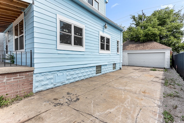 view of home's exterior with a garage and an outdoor structure