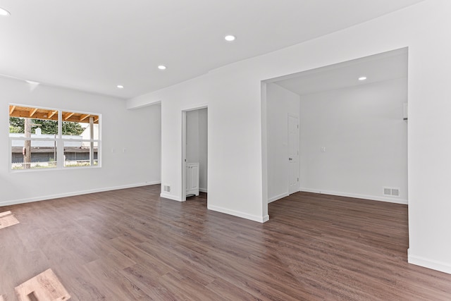 empty room with dark hardwood / wood-style floors