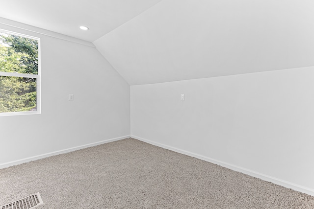 bonus room featuring carpet and vaulted ceiling