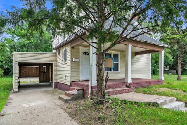 view of front of property with covered porch and a carport