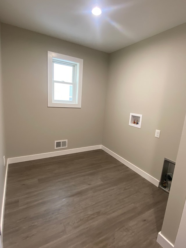 clothes washing area featuring washer hookup and dark hardwood / wood-style flooring