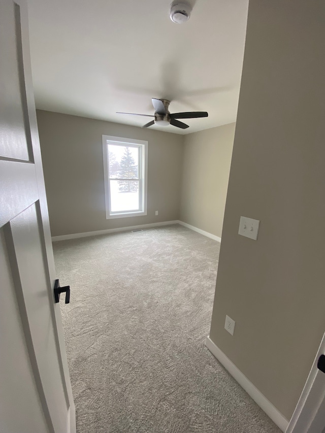 carpeted empty room with ceiling fan