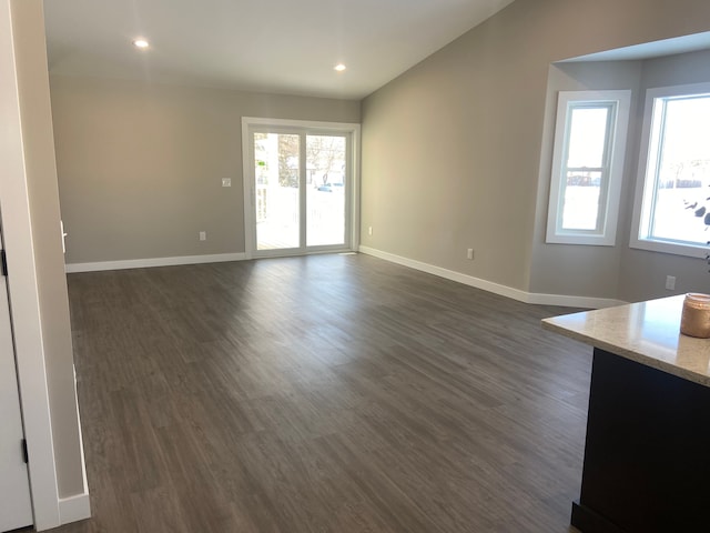 unfurnished living room featuring dark hardwood / wood-style floors