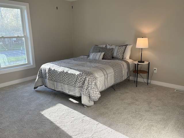 1473 Mallard Cir, Owosso, MI 48867 - carpeted bedroom featuring visible vents and baseboards