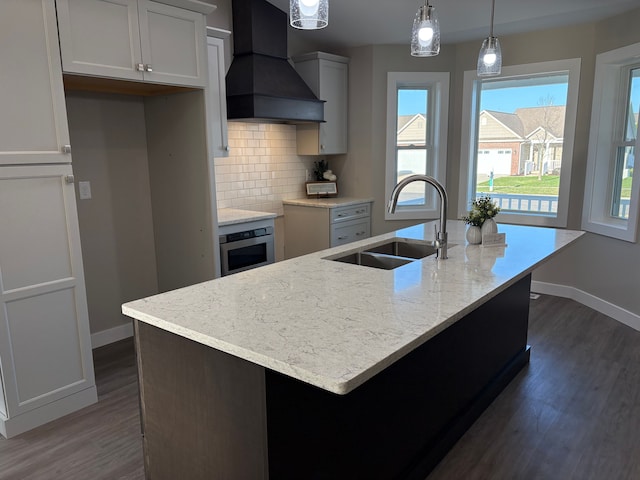 1473 Mallard Cir, Owosso, MI 48867 - kitchen featuring dark wood-style flooring, a sink, custom exhaust hood, baseboards, and stainless steel oven
