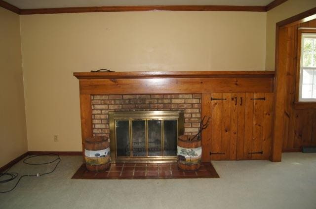 interior details featuring carpet flooring, a brick fireplace, and ornamental molding