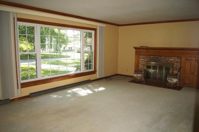 unfurnished living room featuring crown molding, carpet floors, and a fireplace